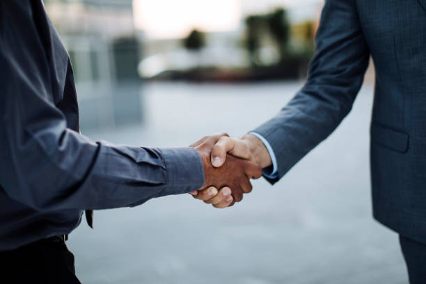 close up shot of two unrecognizable businessman shaking hands